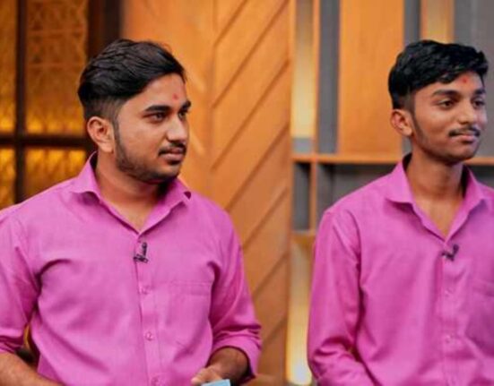 Prakashbhai brothers standing beside a tea vending machine, bringing positive change to tea vendors' lives.