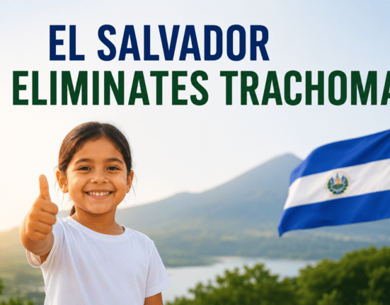 Smiling child with the El Salvador flag celebrating the elimination of trachoma.