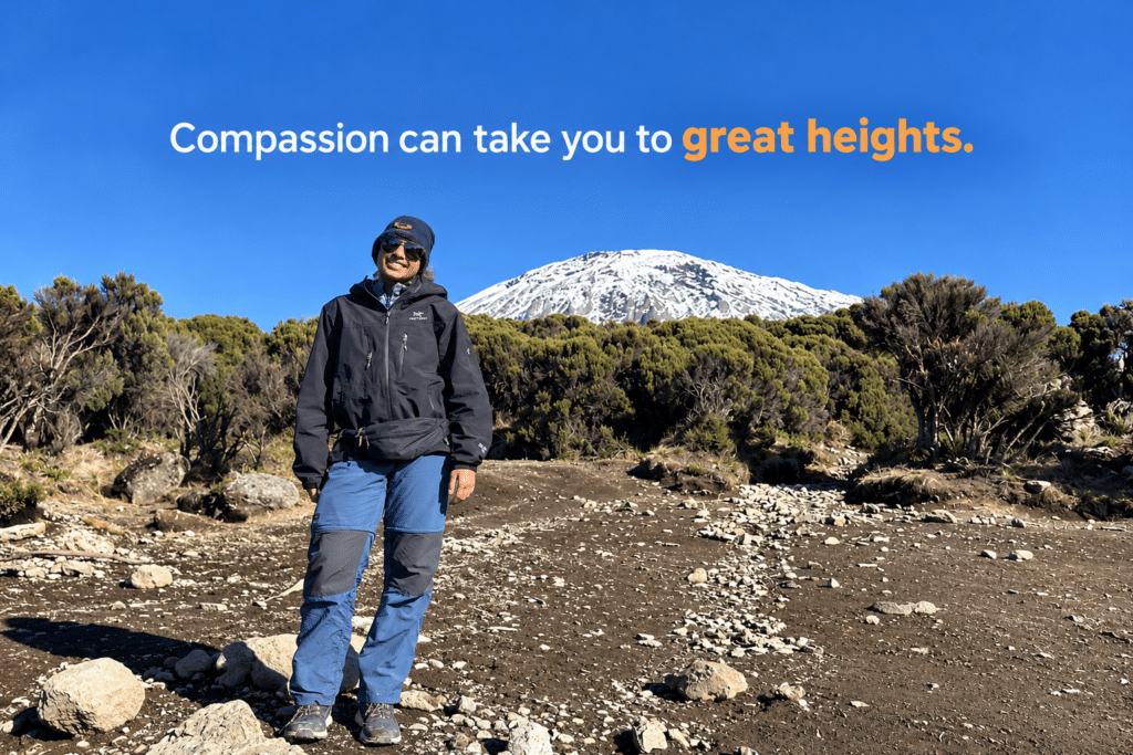 Ananya Jain standing on Mount Kilimanjaro with a snow-covered peak in the background.